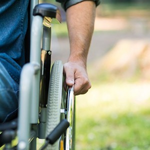 a person in a wheelchair gripping onto their wheel